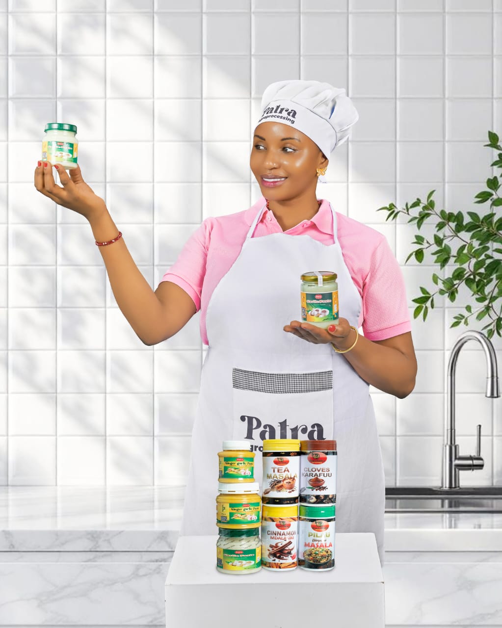 Patra team member in chef uniform presenting garlic paste and spice range